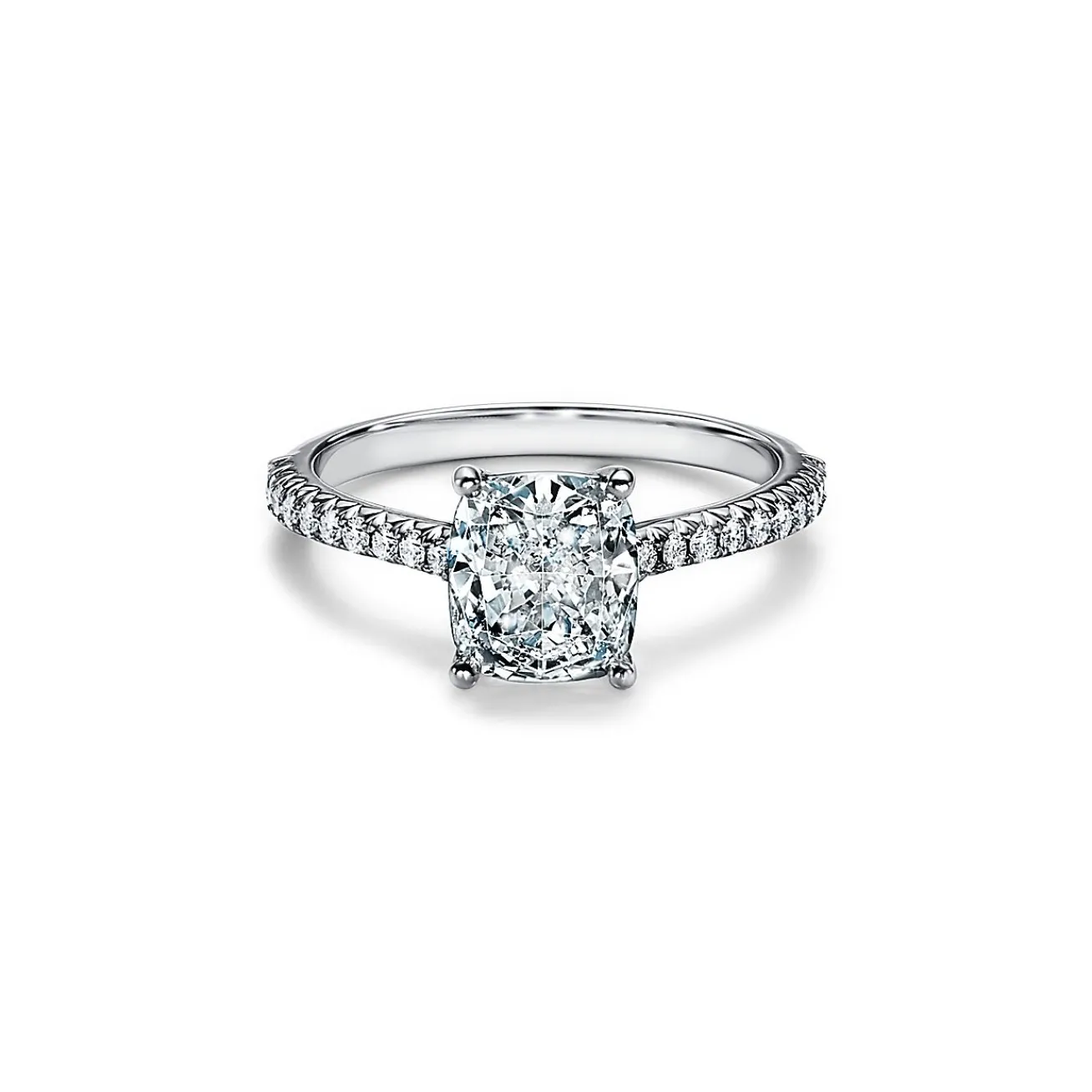 Tiffany & Co. Tiffany Novo® cushion-cut engagement ring with a pavé diamond band in platinum. | ^ Engagement Rings