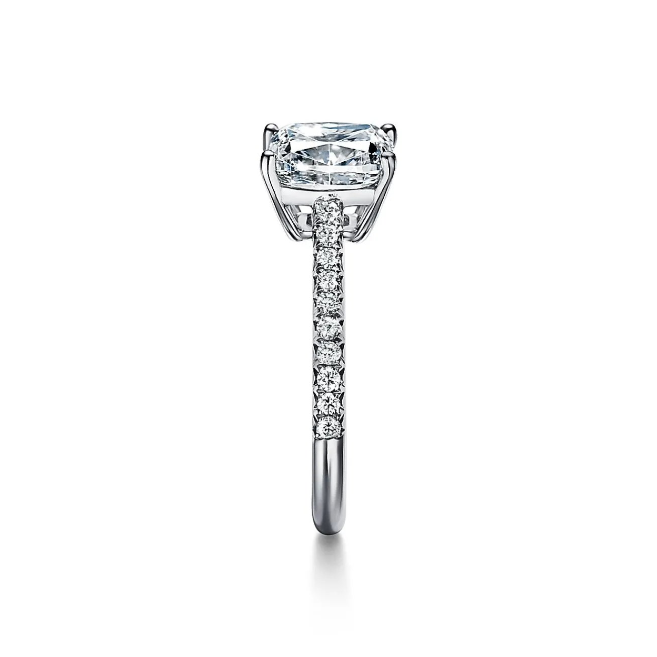 Tiffany & Co. Tiffany Novo® cushion-cut engagement ring with a pavé diamond band in platinum. | ^ Engagement Rings