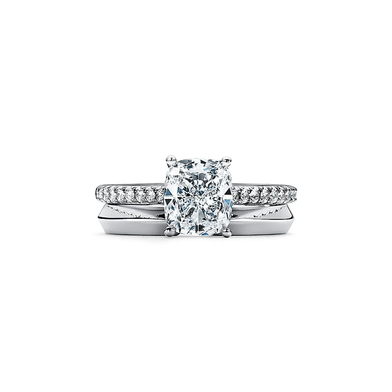 Tiffany & Co. Tiffany Novo® cushion-cut engagement ring with a pavé diamond band in platinum. | ^ Engagement Rings