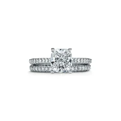 Tiffany & Co. Tiffany Novo® cushion-cut engagement ring with a pavé diamond band in platinum. | ^ Engagement Rings