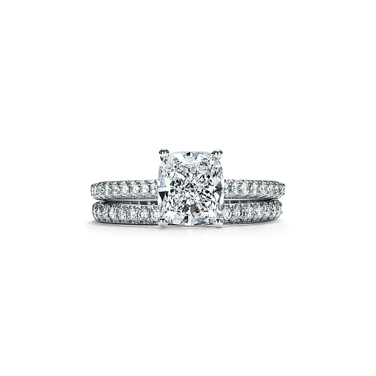 Tiffany & Co. Tiffany Novo® cushion-cut engagement ring with a pavé diamond band in platinum. | ^ Engagement Rings