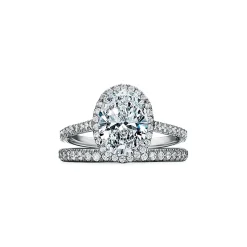 Tiffany & Co. Tiffany Soleste® oval halo engagement ring with a diamond band in platinum. | ^ Engagement Rings