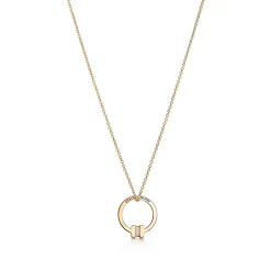 Tiffany & Co. Tiffany T pendant in 18k gold with a baguette diamond. | ^ Necklaces & Pendants|Men's Jewelry