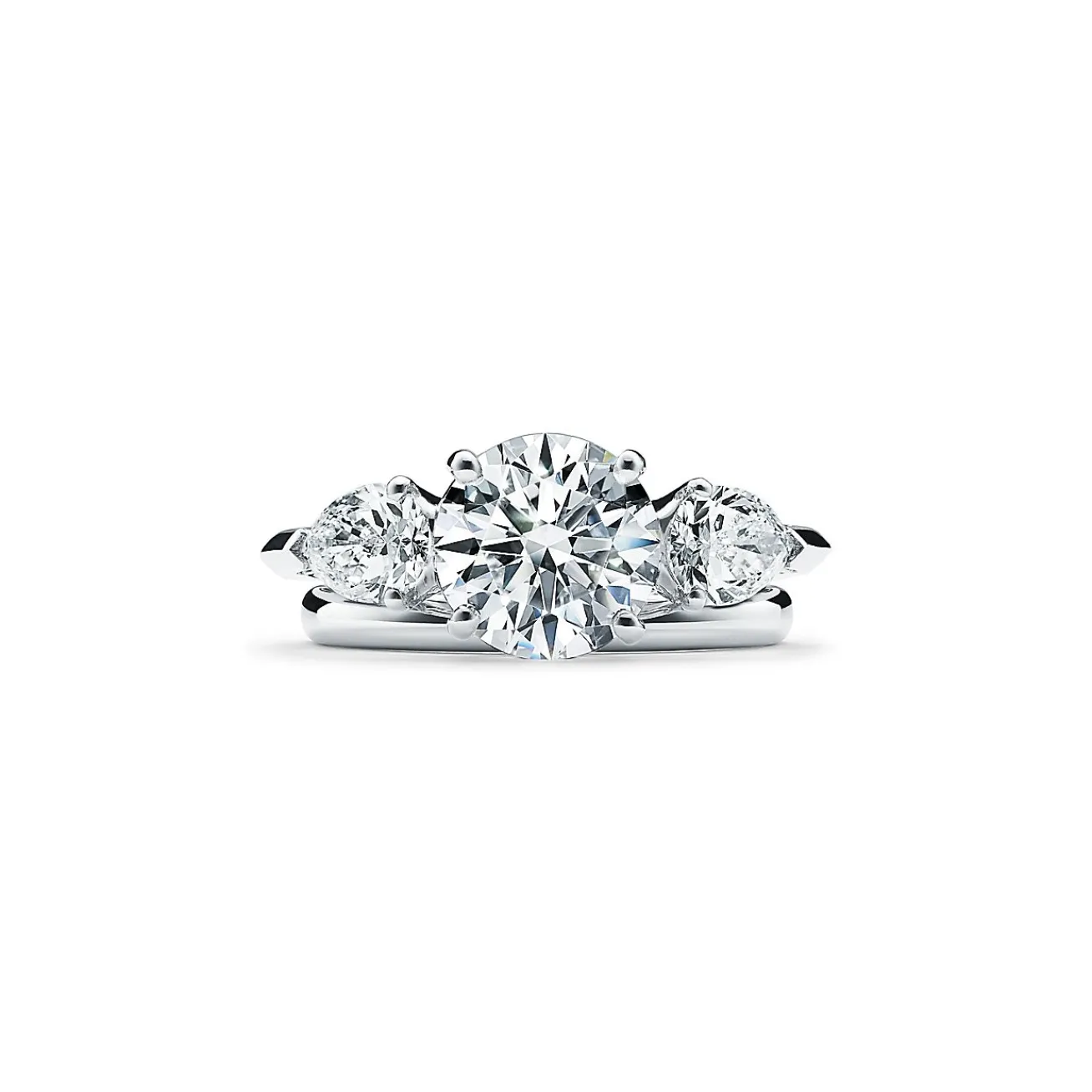 Tiffany & Co. Tiffany Three Stone engagement ring with pear-shaped side stones in platinum. | ^ Engagement Rings