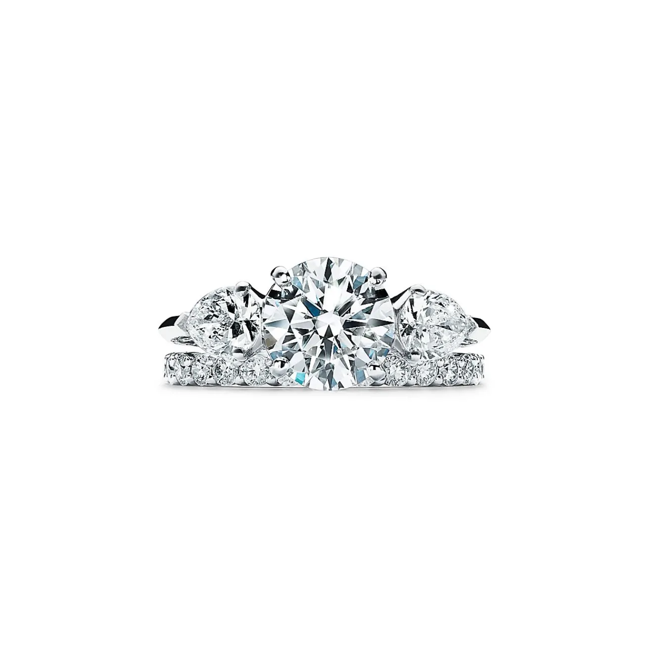 Tiffany & Co. Tiffany Three Stone engagement ring with pear-shaped side stones in platinum. | ^ Engagement Rings