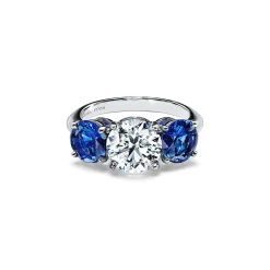 Tiffany & Co. Tiffany Three Stone engagement ring with sapphire side stones in platinum. | ^ Engagement Rings