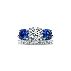 Tiffany & Co. Tiffany Three Stone engagement ring with sapphire side stones in platinum. | ^ Engagement Rings